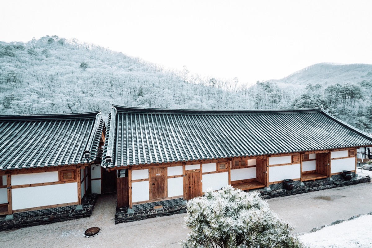Traditional Chinese house in Coloane, Macau, showing a wooden gate and a stone path leading to the sea